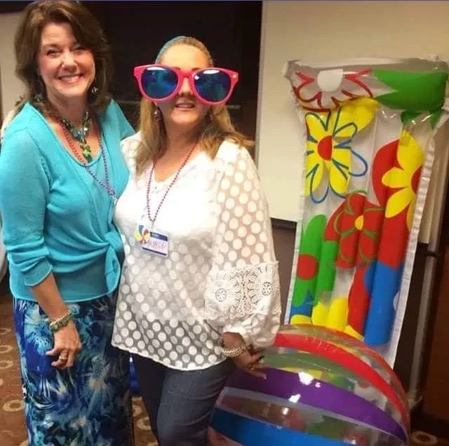 Two women posing at event