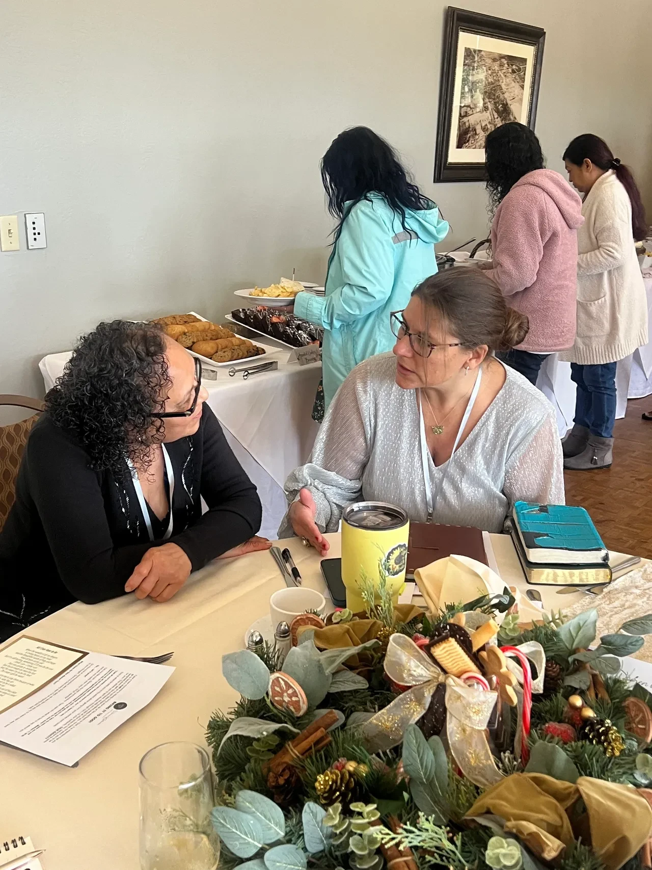 Women in conversation at event table