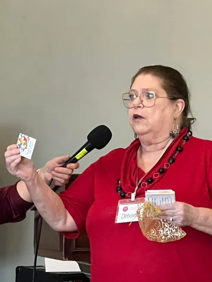 Woman speaking at event with microphone