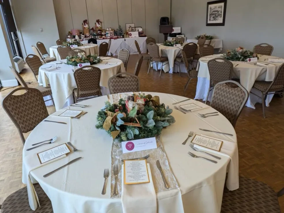 Elegantly set event room with round tables and floral centerpieces