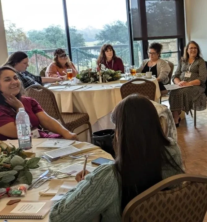 Women gathered at tables during event session