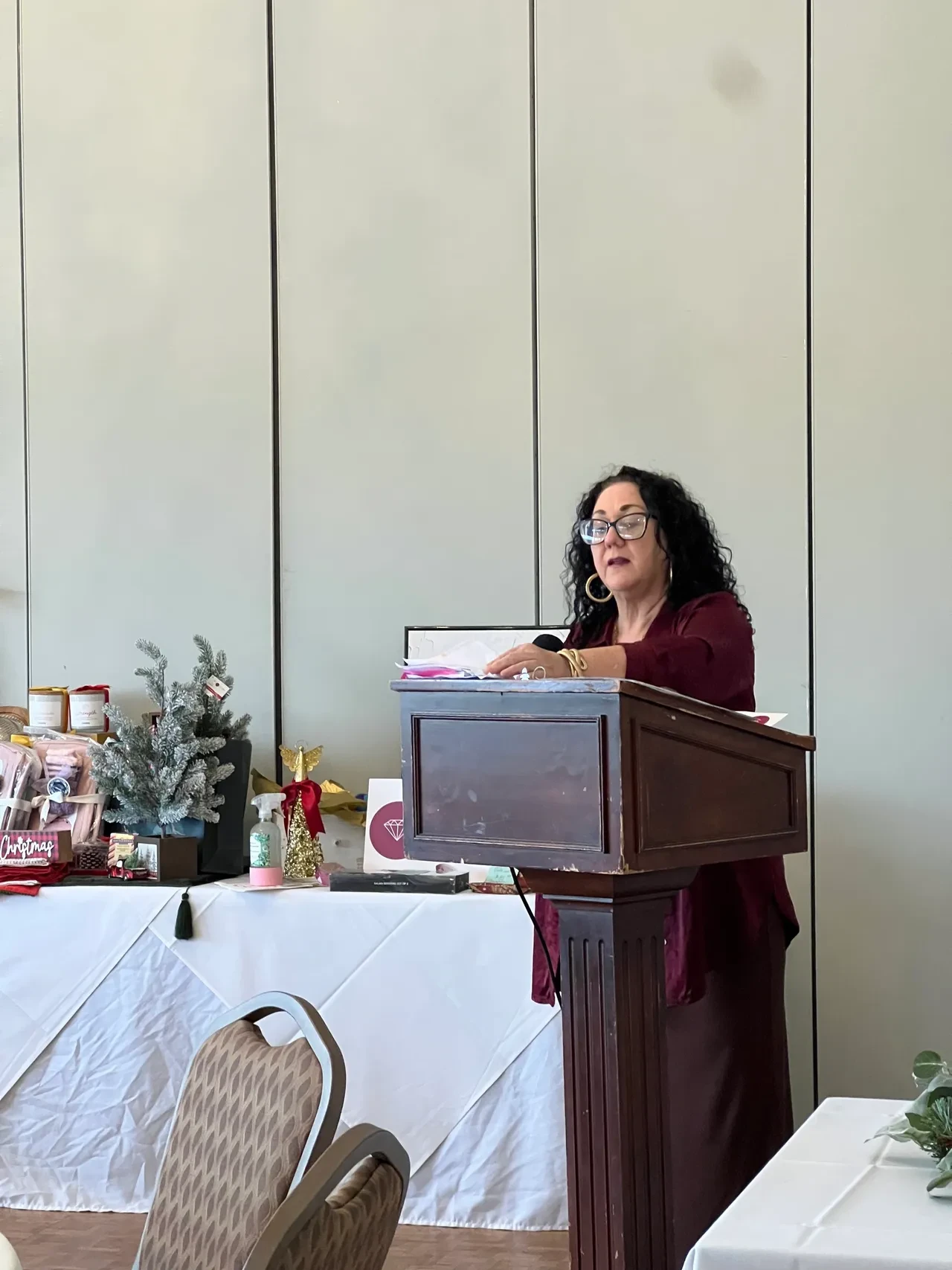 Woman speaking at podium during Women of Splendor event